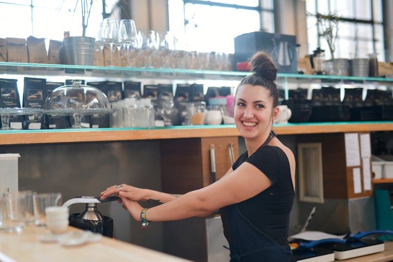 Wing Snob team member smiling in restaurant uniform